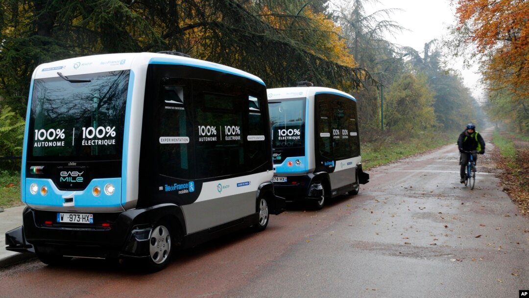 An electric driverless shuttle produced by EasyMile drives, as part of an experiment, in Paris, Friday, Nov. 17, 2017. The full-electric autonomous vehicle is made by French company EasyMile, one of multiple French driverless car projects. (AP Photo/Christophe Ena)