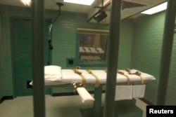 FILE - The death chamber is seen through the steel bars from the viewing room at the state penitentiary in Huntsville, Texas, Sept. 29, 2010.