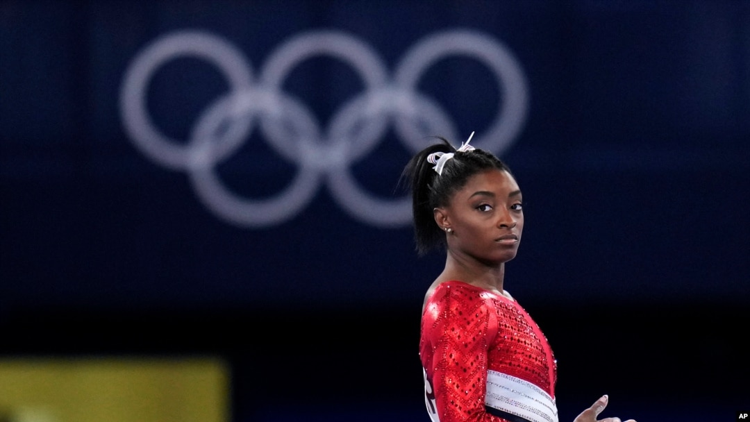 Simone Biles, of the United States, lands from the vault during the artistic gymnastics women's final at the 2020 Summer Olympics, July 27, 2021, in Tokyo.