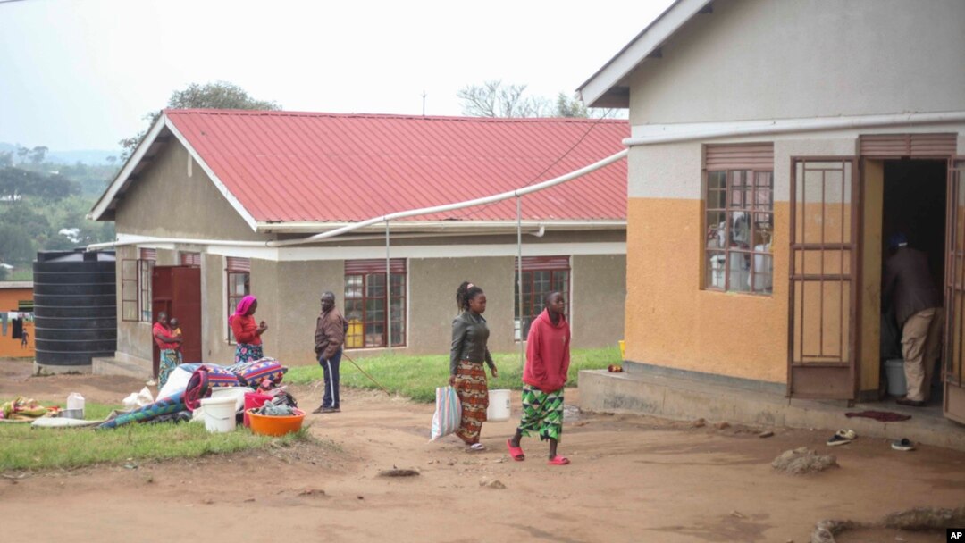 Newly arrived refugees walk at a reception center where they will be registered as refugees at Rwamwanja Refugee Settlement in Kamwenge District, Uganda, on Oct. 21, 2024.