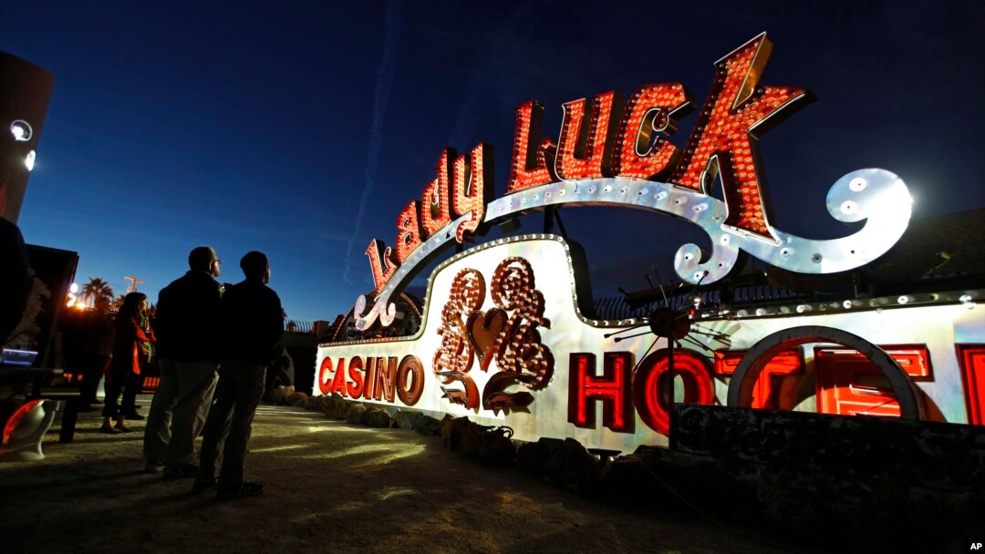 In this Jan. 24, 2018, photo, projectors light up non-working neon signs at an exhibit at the Neon Museum in Las Vegas. Starting this week, visitors will be able to see many of the city's classic neon signs just like they were decades ago through a type of augmented reality that projects realistic animations onto the non-working signs. (AP Photo/John Locher)