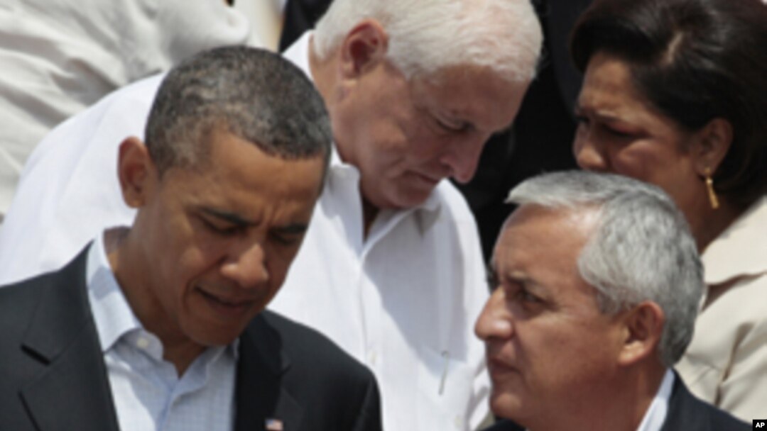 President Barack Obama, left, talks to Guatemala's President Otto Perez at the sixth Summit of the Americas in Cartagena, Colombia, Sunday April 15, 2012.