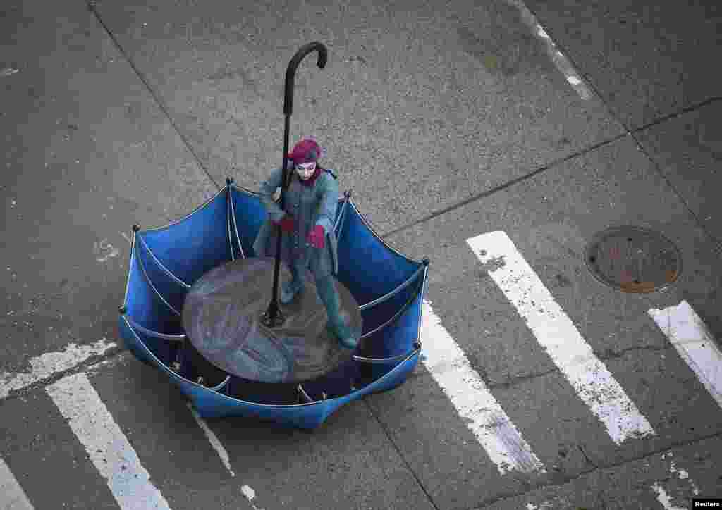 A woman in an upside-down umbrella float makes her way down 6th Ave. during the 87th Macy's Thanksgiving day parade in New York.
