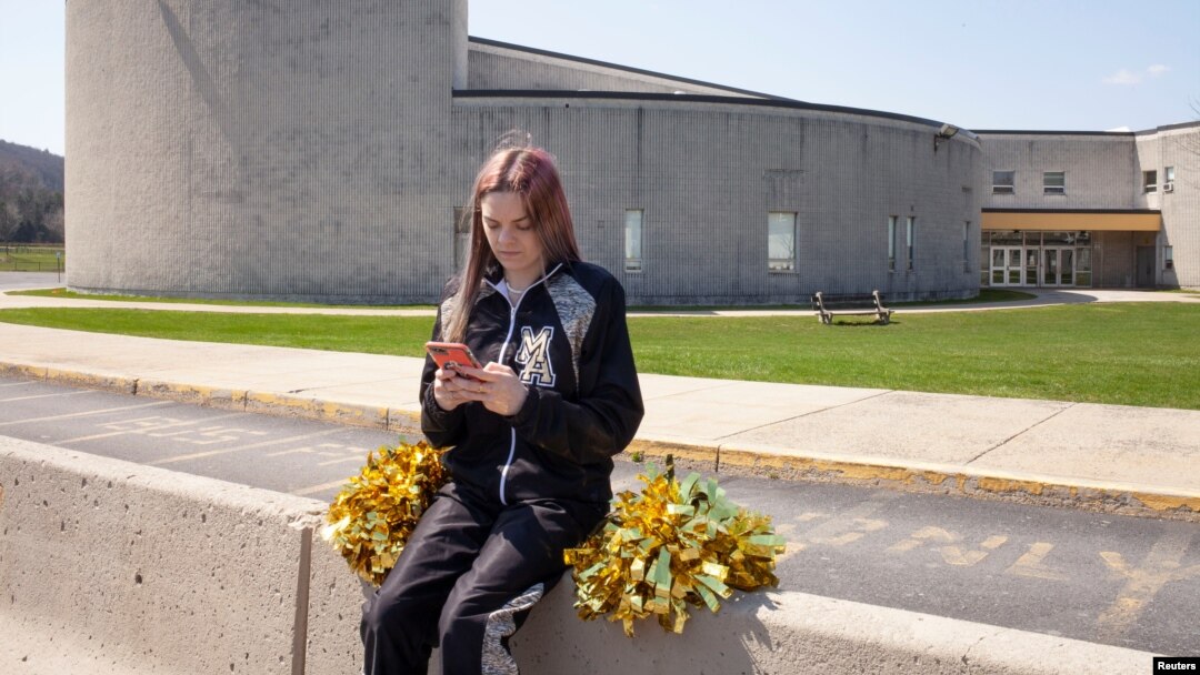 Brandi Levy poses outside of her high school in Pennsylvania. She tried out for the cheerleading team a number of years ago, prompting a social media post that will now be discussed by the U.S. Supreme Court. (Danna Singer/Handout via REUTERS)