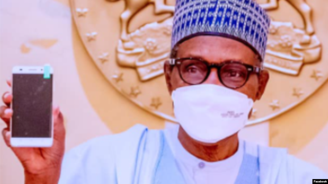 Shugaba Buhari yana nuna wayar salular da Najeriya ta hada a karon farko (Facebook/Bashir Ahmad)