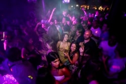 People drink on the dance floor shortly after the reopening, at The Piano Works in Farringdon, in London, July 19, 2021.