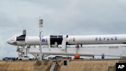 The SpaceX Falcon 9 rocket, with Dragon crew capsule, is serviced on Launch Pad 39-A, May 26, 2020, at the Kennedy Space Center in Cape Canaveral, Florida. 