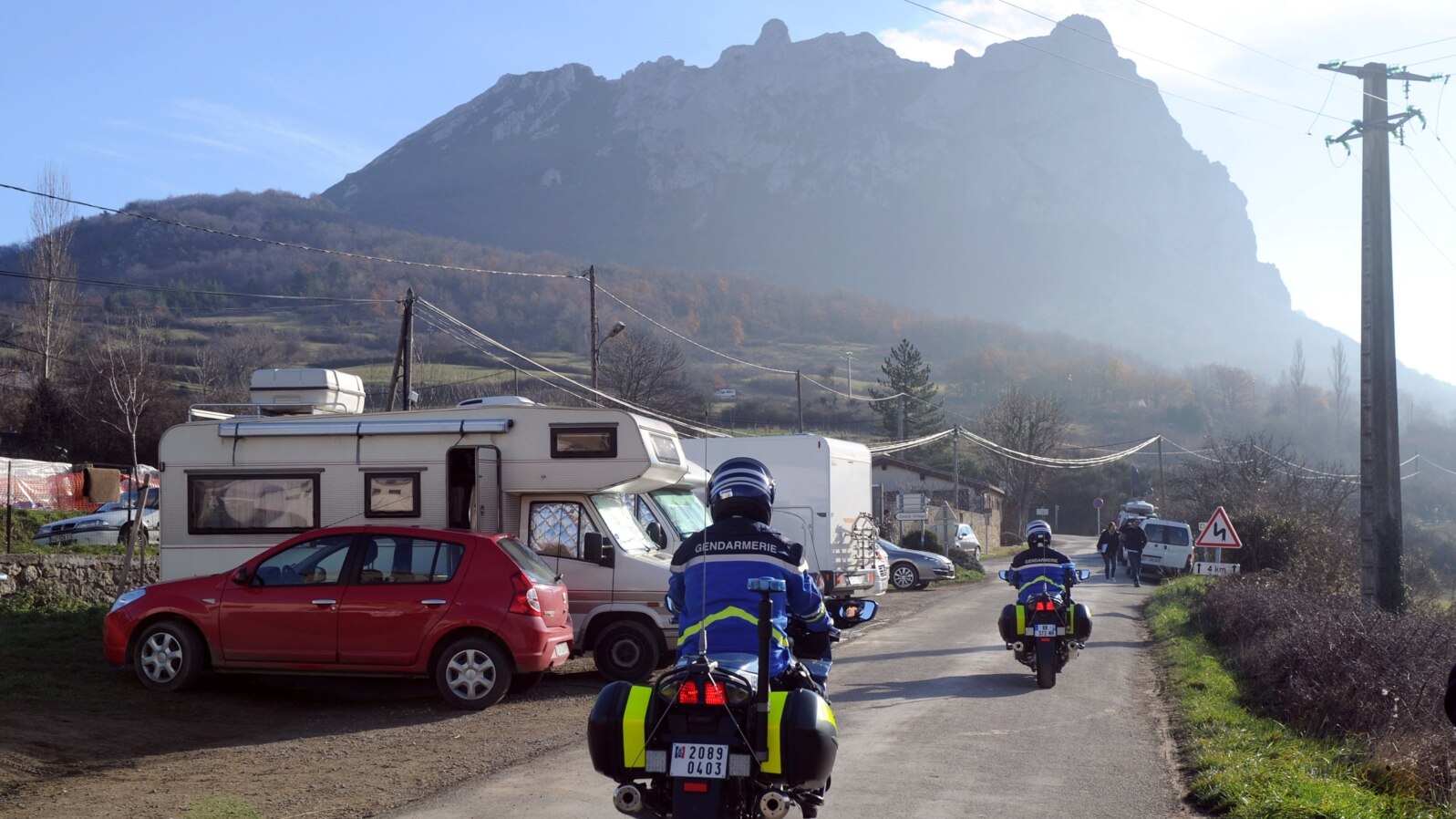 French Gendarmes patrol a street o where mobile-homes parked, on December 20, 2012, in the French southwestern village of Bugarach.