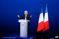 French far-right presidential candidate Marine Le Pen attends her meeting, May 1, 2017, in Villepinte, outside Paris.