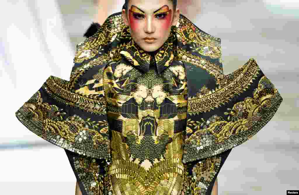 A model presents a creation for a make-up styling show by Mao Geping at China Fashion Week in Beijing, China.