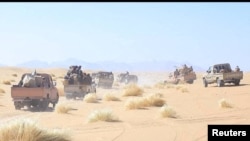 Yemeni government army soldiers ride in the backs of pickup trucks at the frontline of fighting against Houthis in Marib, Yemen, in this undated photo provided by Yemen's Armed Forces, Jan. 14, 2022.