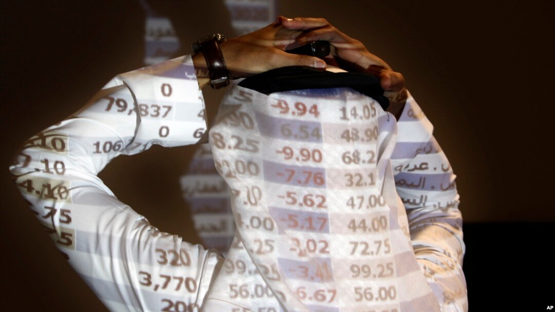 A Saudi trader reacts as looks at the stock market monitor in Riyadh, Saudi Arabia, Oct. 7, 2018. The Saudi stock market sharply fell, Oct. 14, 2018, after President Donald Trump threatened "severe punishment" over the disappearance of Washington Post contributor Jamal Khashoggi. 