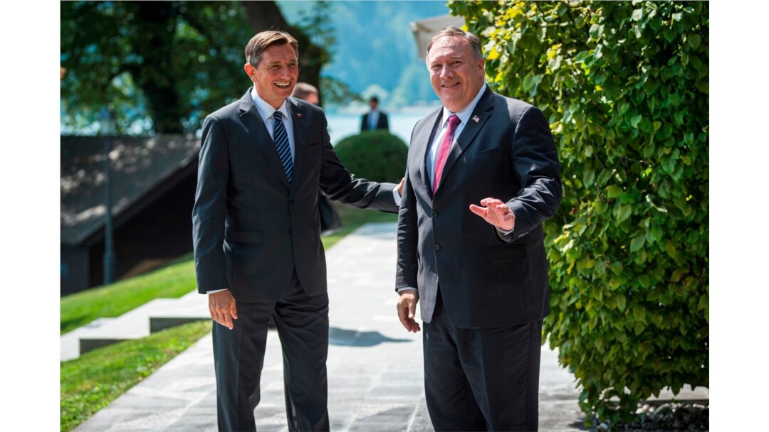 Slovenia's President Borut Pahor, left, welcomes U.S. Secretary of State Mike Pompeo upon his arrival prior to their meeting in Bled, Aug. 13, 2020.