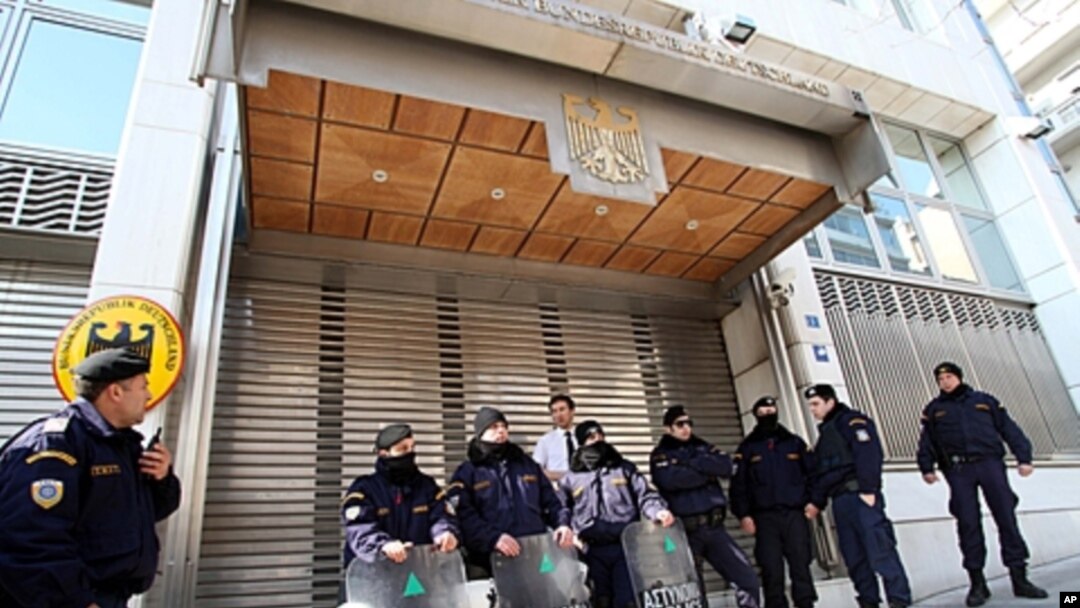 Riot police secure the entrance to the German Embassy during an anti-austerity protest in Athens, February 17, 2012.