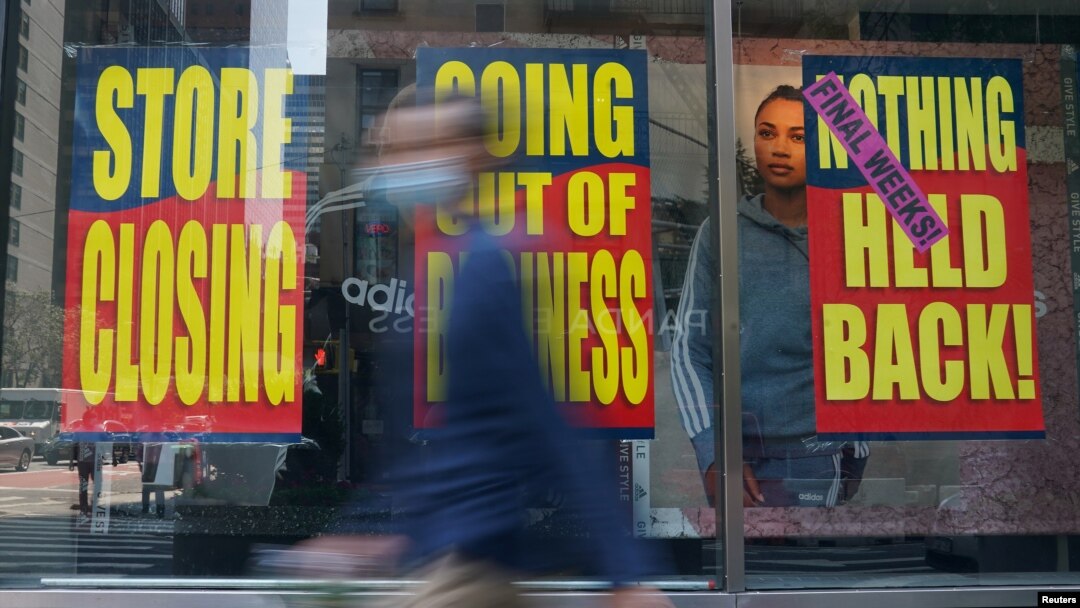 People walk past a business that is closing following the outbreak of COVID-19 in the Manhattan borough, New York, Aug. 17, 2020.
