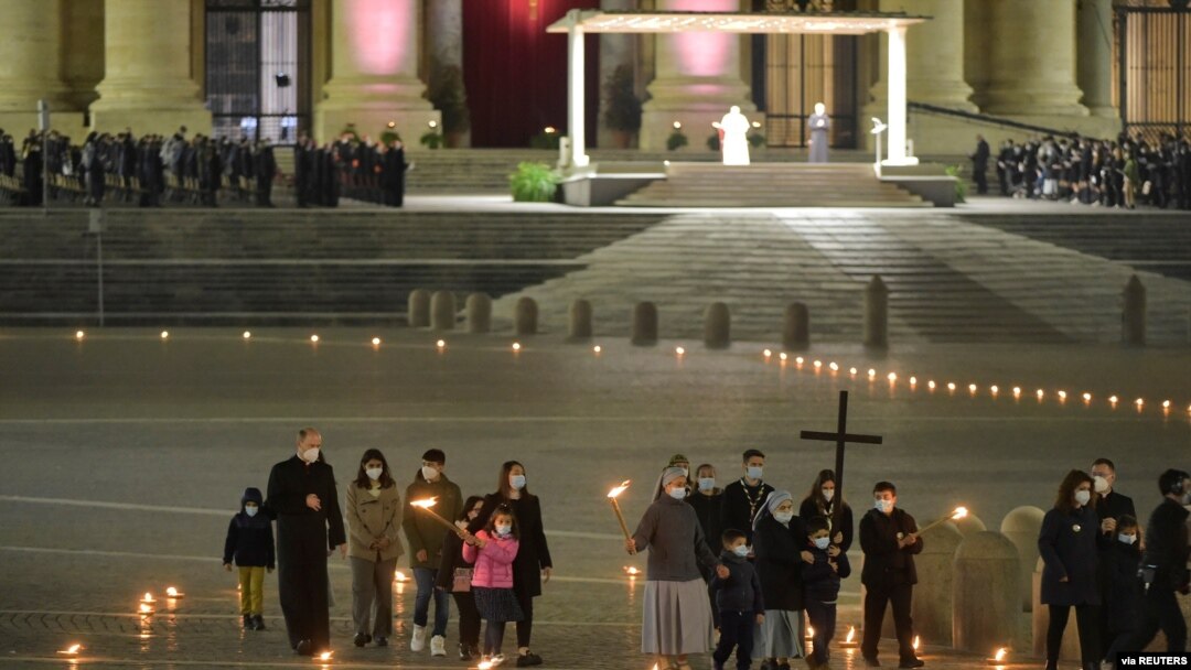 Pope Francis officiates at the Via Crucis (Way of the Cross) procession in a near empty square outside Saint Peter's Basilica during Good Friday observances at the Vatican, April 2, 2021. (Vatican Media/Handout via Reuters) 