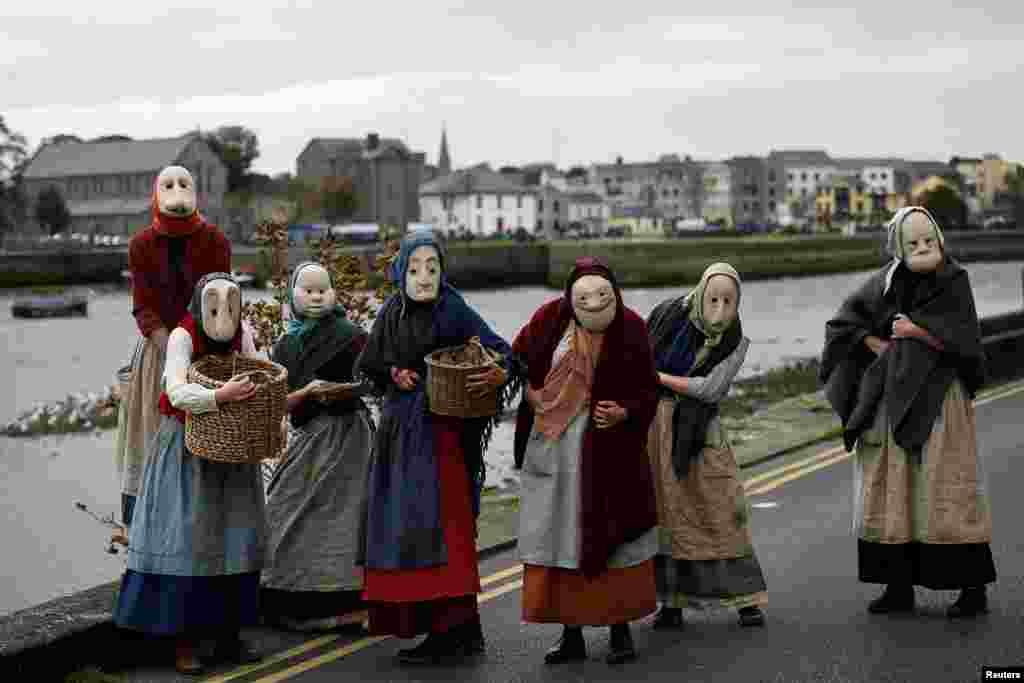 Actors participate in a street performance called 'The Fisherwives', by Bru Theatre group, representing part of the fishing community from 100 years ago, at the Spanish Arch in Galway, Ireland.
