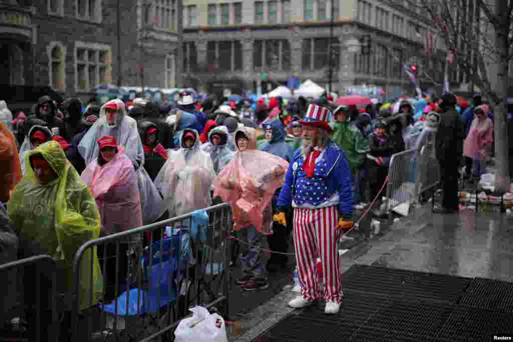 A man dressed as Uncle Sam looks on as supporters line up outside Capital One Arena, ahead of a rally for U.S. President-elect Donald Trump the day before he is scheduled to be inaugurated for a second term, in Washington.