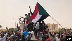 Wasudan wakiimba nyimbo wakati wa maandamano dhidi ya jeshi mjini Khartoum.