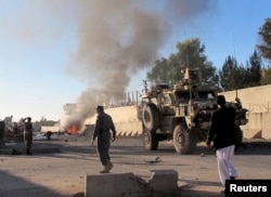 FILE - Smoke bellows after a suicide car bomb blast attacked a military convoy in Lashkar Gah, Helmand province, Afghanistan, Nov. 15, 2015.