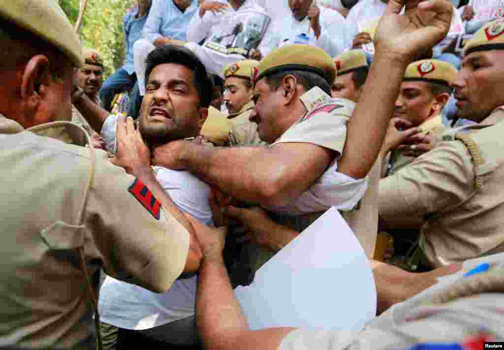 Supporters of India's main opposition Congress party scuffle with police during a protest demanding the resignation of India's Minister of State for External Affairs Mobashar Jawed Akbar in New Delhi.