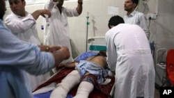 A wounded man receives treatment at a hospital after a suicide car bomb and multiple gunmen attack in the city of Jalalabad, east of Kabul, Afghanistan, Aug. 2, 2020.