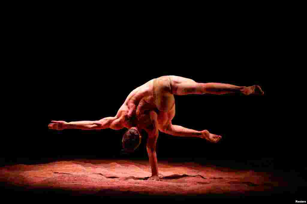 An artist from the dance company Recirquel performs during the dress rehearsal for 'My Land' in Budapest, Hungary, Oct. 15, 2018.