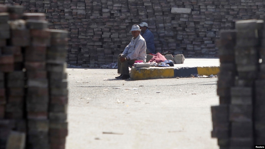 Members of the Muslim Brotherhood and supporters of deposed Egyptian President Mohamed Morsi rest amongst bricks stacked throughout their camp in the Nasr City area, east of Cairo Aug. 11, 2013.