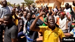 FILE - Civil organizations hold a protest following an attack on a gendarmerie post that killed 32 people, calling for Burkina Faso's President Roch Marc Kabore to resign and for departure of French forces that patrol the country, in Ouagadougou, Burkina Faso, Nov. 16, 2021.