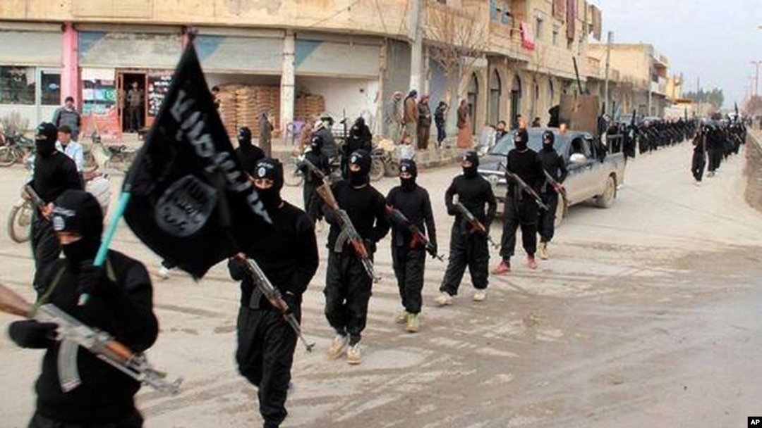 FILE - Fighters from the al-Qaida-linked Islamic State of Iraq and the Levant (ISIL), now called the Islamic State group, march in Raqqa, Syria, Jan. 14, 2014.