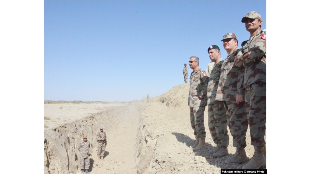Pakistan army officers survey the trench near the border with Afghanistan.