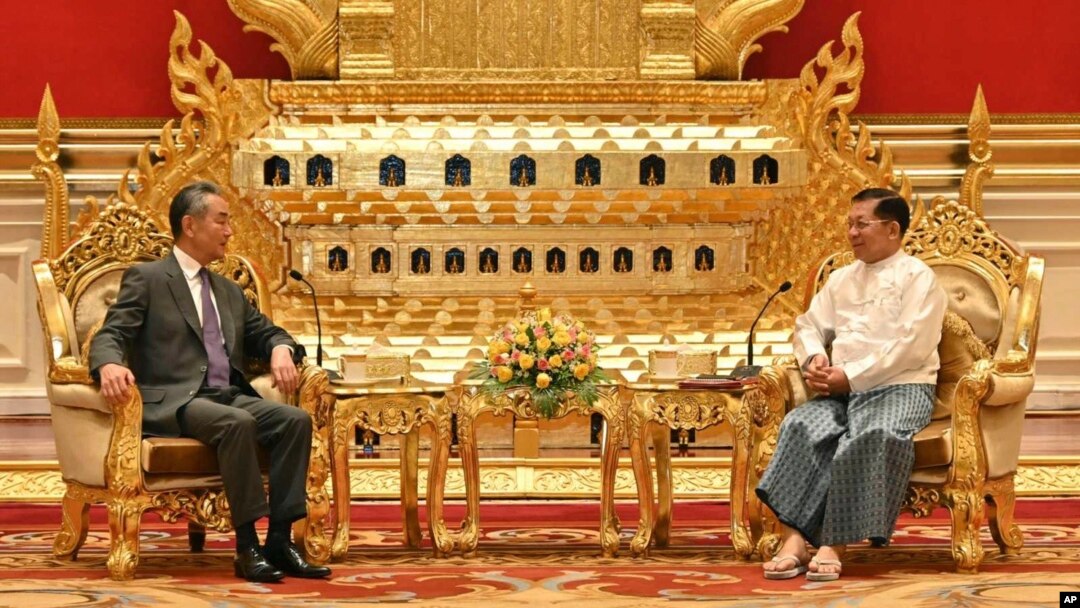 This photo provided by Myanmar Military Information Team, Myanmar's military leader Senior Gen. Min Aung Hlaing, right, chairman of State Administration Council, talks with Chinese Foreign Minister Wang Yi, Aug. 14, 2024, in Naypyitaw, Myanmar. 