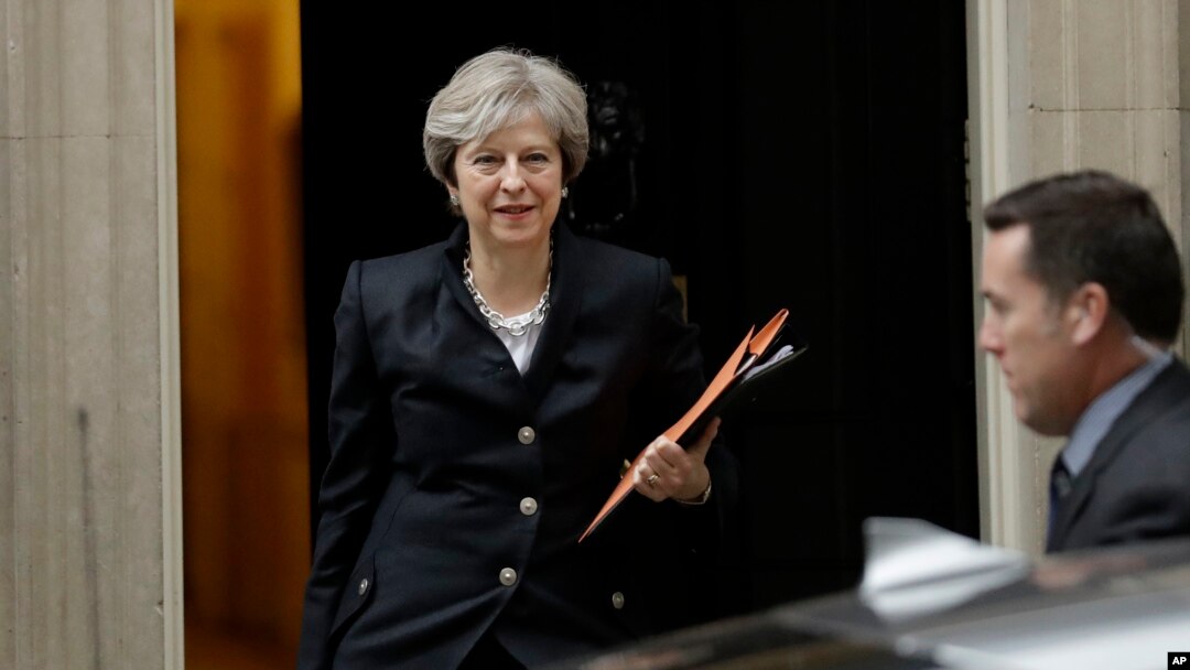 FILE - British Prime Minister Theresa May leaves 10 Downing Street to deliver a statement on Brexit to Parliament in London, Oct. 9, 2017.