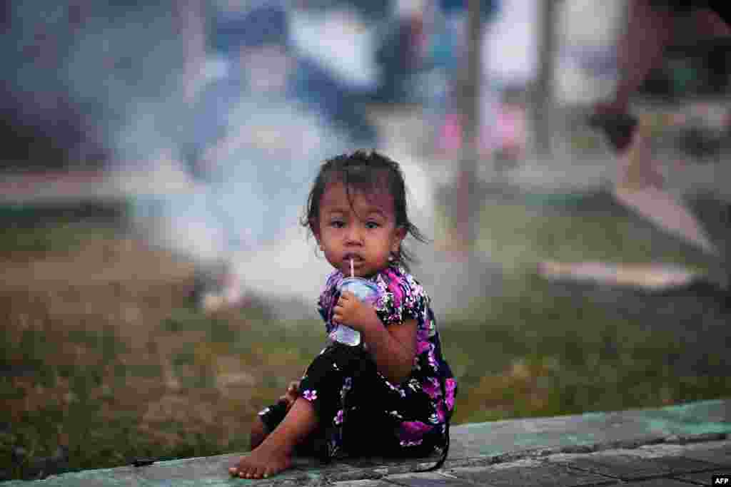 A child drinks water at a makeshift camp in Palu in Indonesia's Central Sulawesi, following the September 28 earthquake and tsunami.