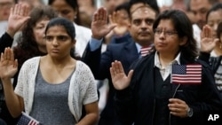 FILE - Immigrants take the citizenship oath during naturalization ceremonies at a U.S. Citizenship and Immigration Services (USCIS) ceremony in Los Angeles, California, Sept. 20, 2017.