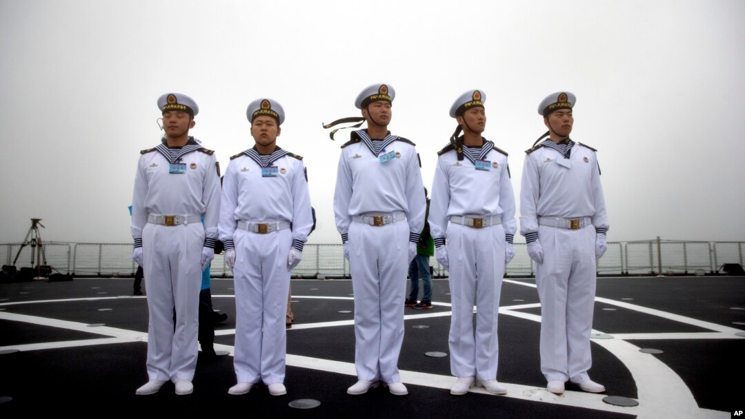 Chinese sailors stand on the deck of the naval training ship Qi Jiguang during a naval parade to commemorate the 70th anniversary of the founding of China's PLA Navy in the sea near Qingdao in eastern China's Shandong province, Tuesday, April 23, 2019.