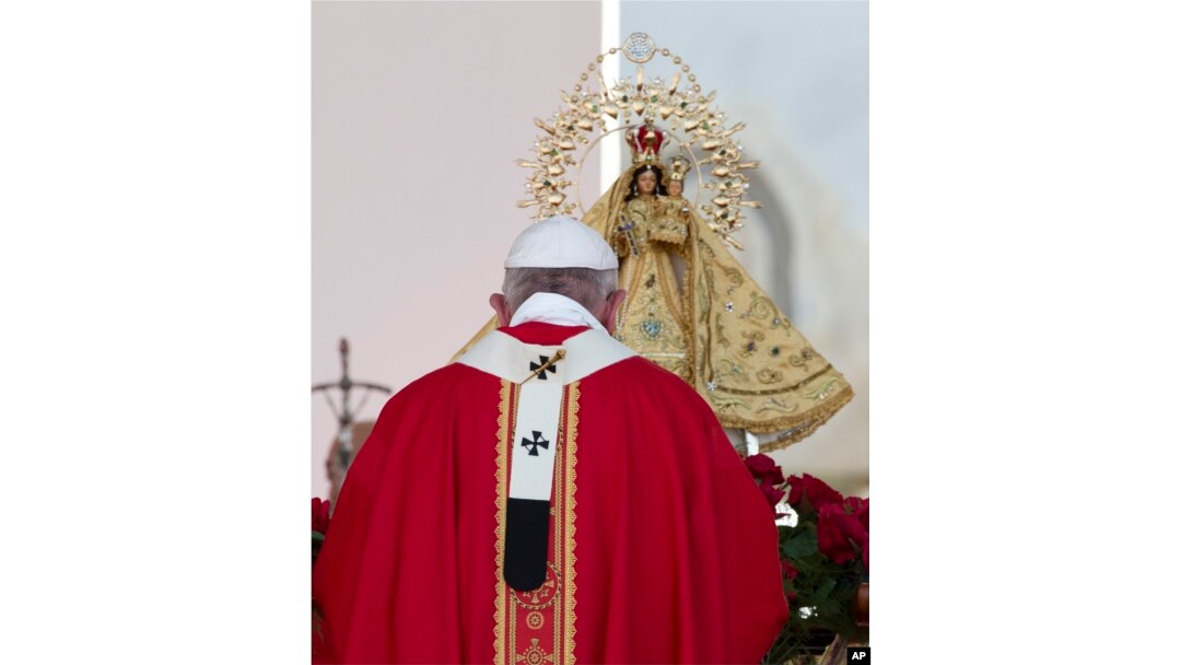 Pope Francis prays before a statue of the Virgin of Charity, Cuba's patron saint, as he arrives to celebrate a Mass at the Plaza of the Revolution, in Holguin, Cuba, Sept. 21, 2015.