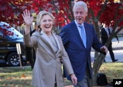 Former Democratic presidential candidate Hillary Clinton, and her husband former President Bill Clinton greet supporters in Chappaqua, N.Y., Nov. 8, 2016.