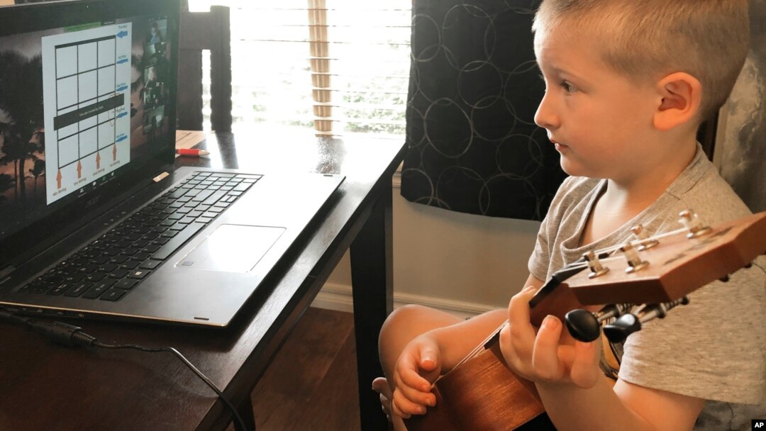 In this May 5, 2020, photo provided by Christina Rothermel-Branham, her son James, does school work at their Tahlequah, Okla., home. (Christina Rothermel-Branham via AP)