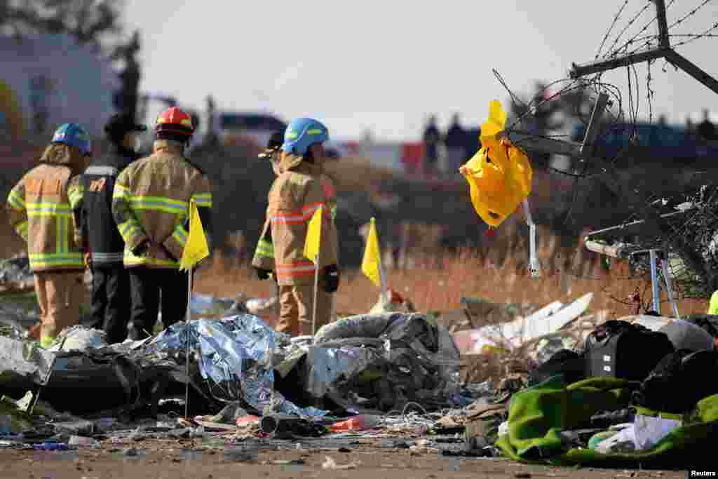 A life jacket hangs on fencing next to the wreckage of the aircraft at Muan International Airport, Dec. 29, 2024. 