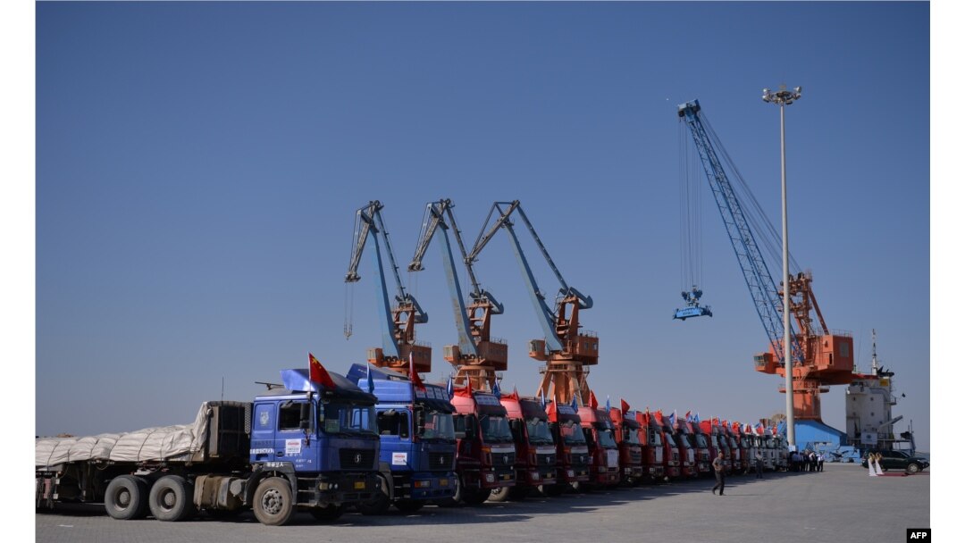 FILE - Chinese trucks stand on a pontoon during the opening of a trade project in Gwadar port, 700 kilometers west of Karachi, Pakistan, Nov. 13, 2016.