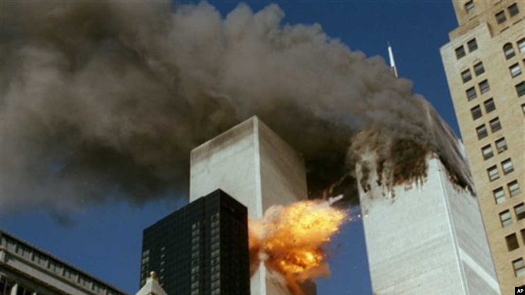 United Airlines Flight 175 collides into the south tower of the World Trade Center in New York as smoke billows from the north tower on September 11, 2001.