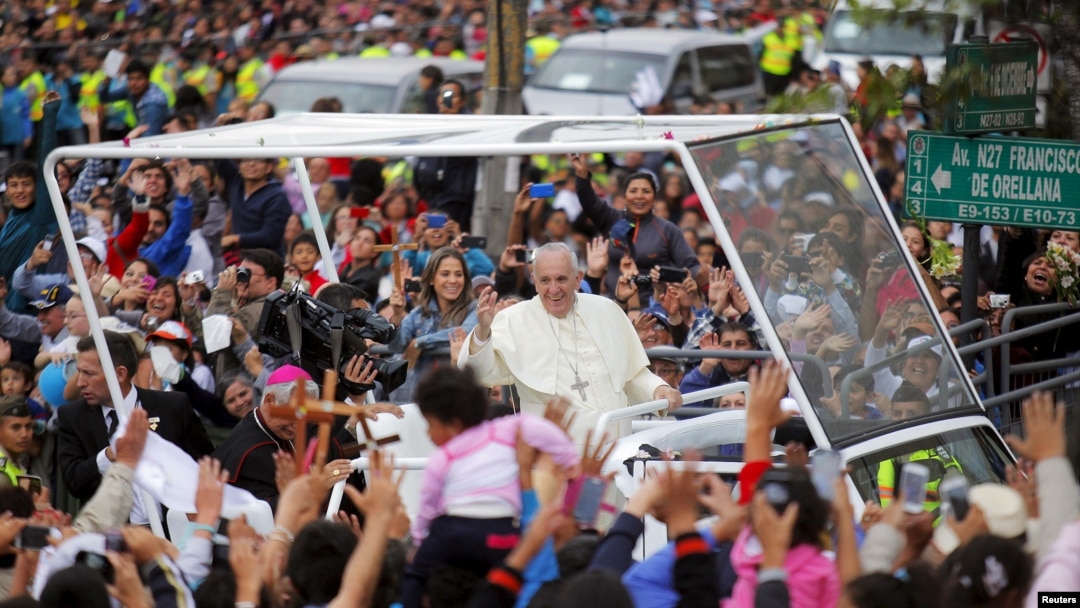 Pope Francis greets the crowd of faithful from a popemobile in Quito, Ecuador, July 5, 2015. 