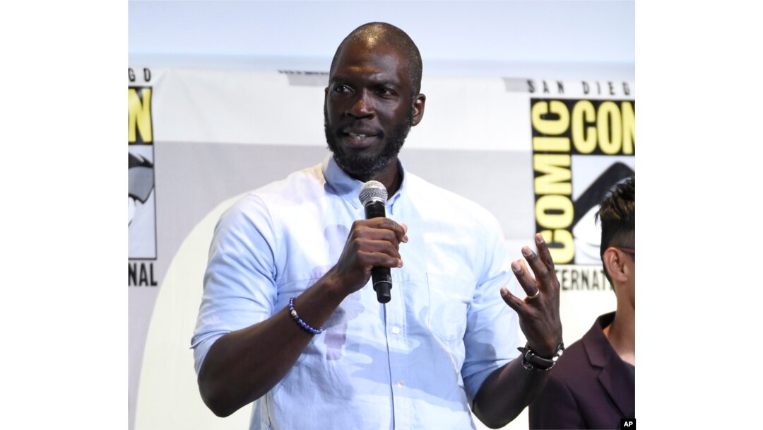 FILE - In this July 23, 2016 file photo, director Rick Famuyiwa speaks at the "Justice League" panel on day 3 of Comic-Con International in San Diego.