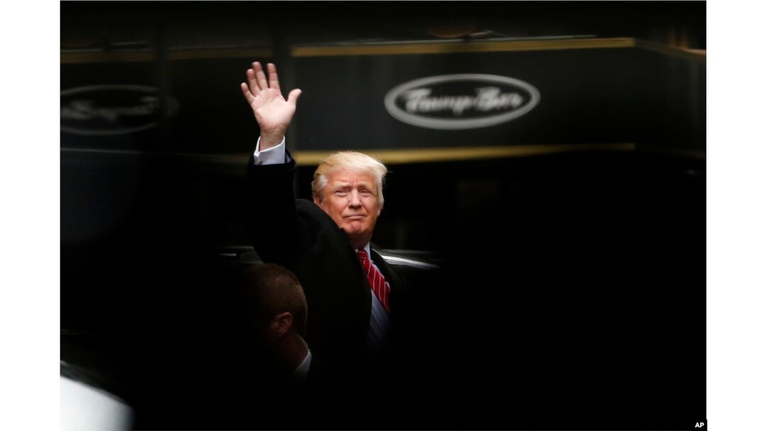 Republican presidential candidate Donald Trump acknowledges supporters while leaving Trump Tower on his way to visit the World Trade Center Museum, in New York, April 9, 2016.