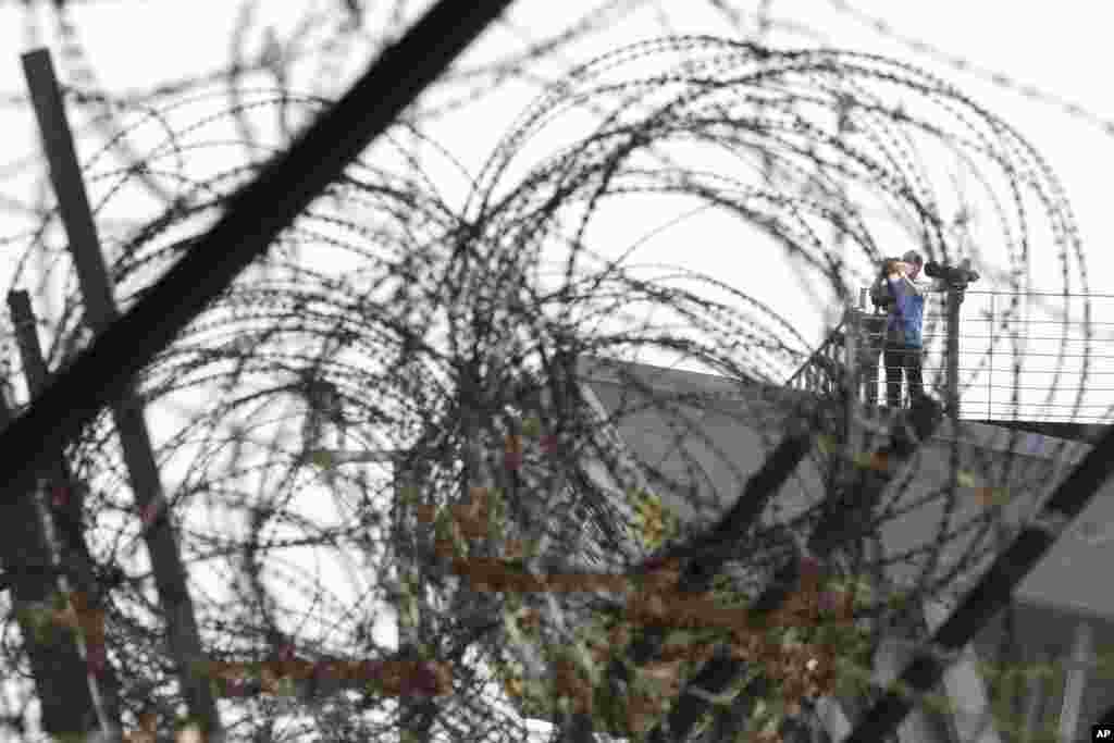 A visitor takes photos toward the North's side at the Imjingak Pavilion in Paju, near the border with North Korea, in South Korea. North Korean leader Kim Jong Un's powerful sister, Kim Yo Jong, said North Korea is willing to resume talks with South Korea.