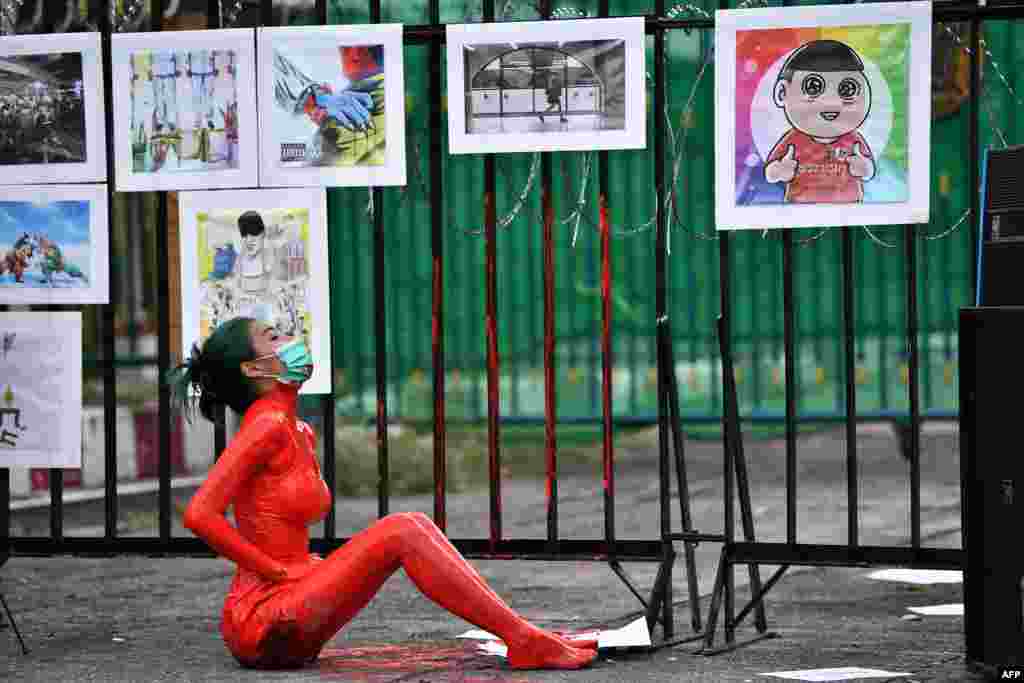 A protester is covered in red paint during a demonstration against the government of Thailand's Prime Minister Prayut Chan-O-Cha and in support of the release of political prisoners outside Bangkok Remand Prison in Bangkok.