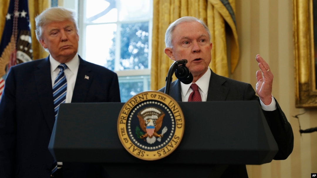 President Donald Trump listens as Attorney General Jeff Sessions speaks in the Oval Office of the White House in Washington, after Vice President Mike Pence administered the oath of office to Sessions. 