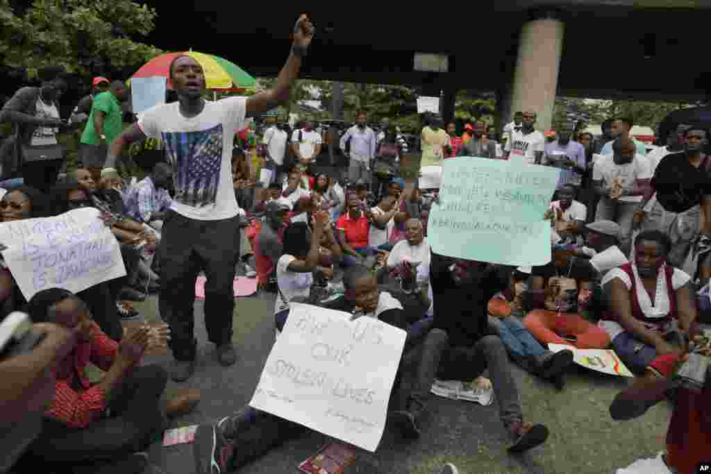People attend a demonstration calling on government to rescue kidnapped school girls of a government secondary school Chibok, during workers day celebration in Lagos, Nigeria. Thursday, May, 1. 2014, Scores of girls and young women kidnapped from a scho