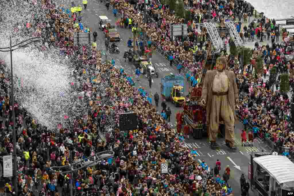 A huge puppet named Giant walks past the dockside in central Liverpool, north west England during a production by French street theater company Royal de Luxe entitled Liverpool's Dream.